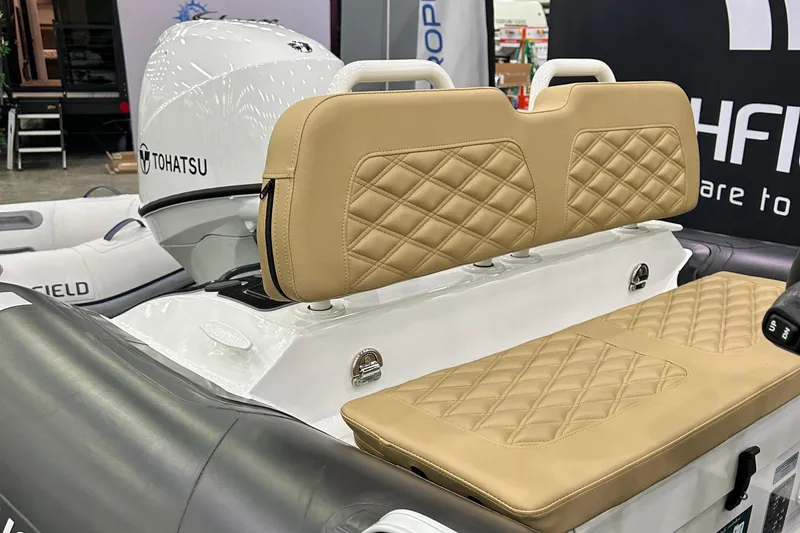 Slide: The Image of 2024 Highfield Sport 390 boat with tan quilted seats and Tohatsu engine. - 6