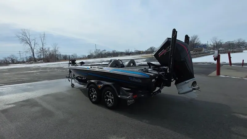 Slide: The Image of 2025 Bass Cat Cougar FTD boat on trailer in snowy parking lot. - 10