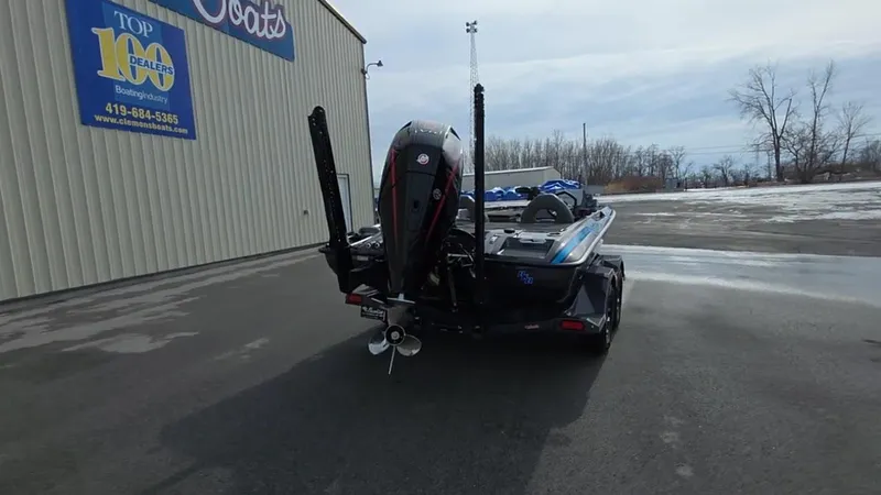 Slide: The Image of 2025 Bass Cat Cougar FTD boat parked outside dealership on a cloudy day. - 11