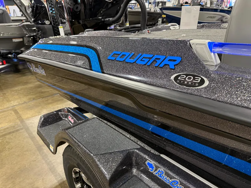Slide: The Image of 2025 Bass Cat Cougar FTD boat with sleek design and blue accents on display. - 12