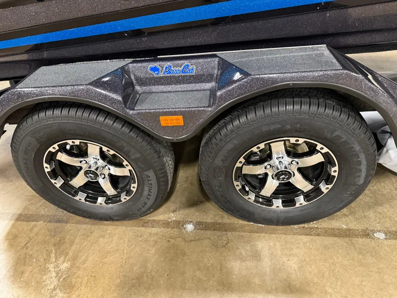 Slide: The Image of 2025 Bass Cat Cougar FTD trailer wheels with chrome rims on concrete floor. - 15