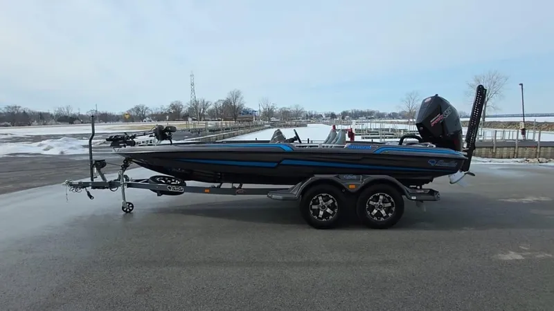Slide: The Image of 2025 Bass Cat Cougar FTD boat on trailer, parked in snowy landscape. - 4