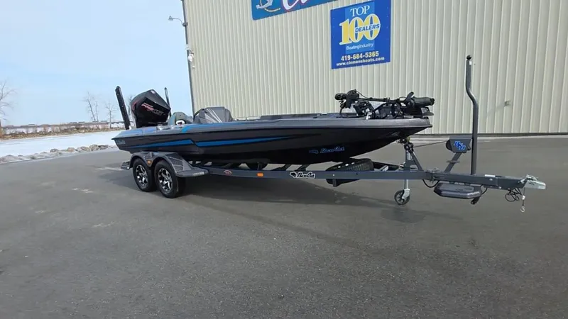 Slide: The Image of 2025 Bass Cat Cougar FTD boat on trailer, parked outside dealership. - 5