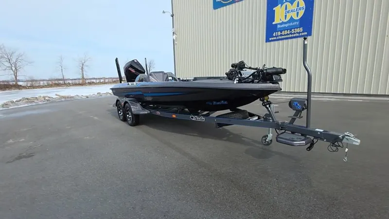 Slide: The Image of 2025 Bass Cat Cougar FTD boat on trailer in parking lot. - 7