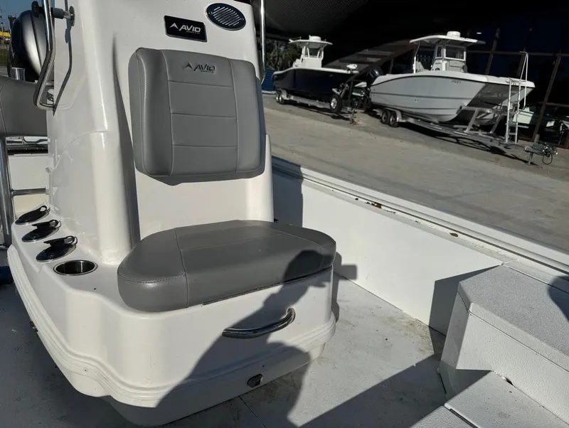 Slide: The Image of 2021 Avid 21 FS boat interior with gray seating and cup holders. - 11