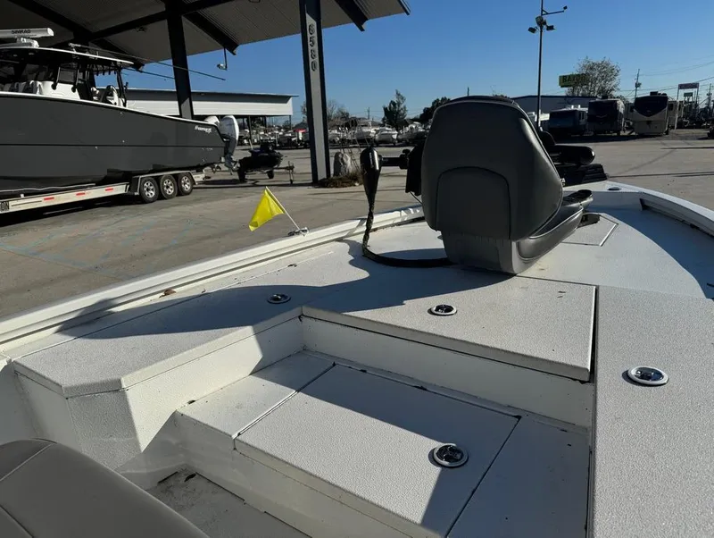 Slide: The Image of 2021 Avid 21 FS boat at a dealership, showcasing seating and control area. - 12