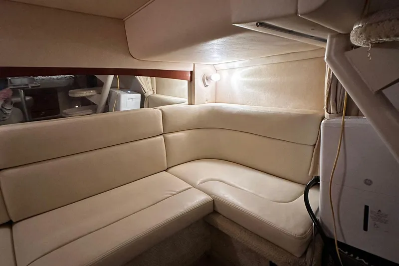 Slide: The Image of Interior of 2002 Sea Ray 320 Sundancer with beige leather seating. - 11