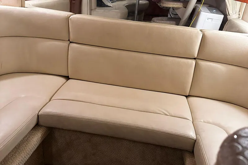 Slide: The Image of Beige leather seating in 2002 Sea Ray 320 Sundancer yacht interior. - 12