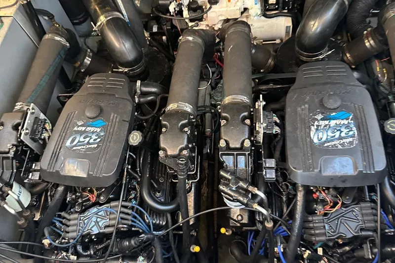 Slide: The Image of Twin engines of a 2002 Sea Ray 320 Sundancer boat. - 13