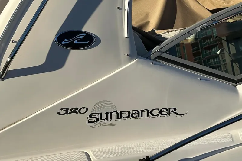 Slide: The Image of Close-up of 2002 Sea Ray 320 Sundancer boat logo and branding. - 14