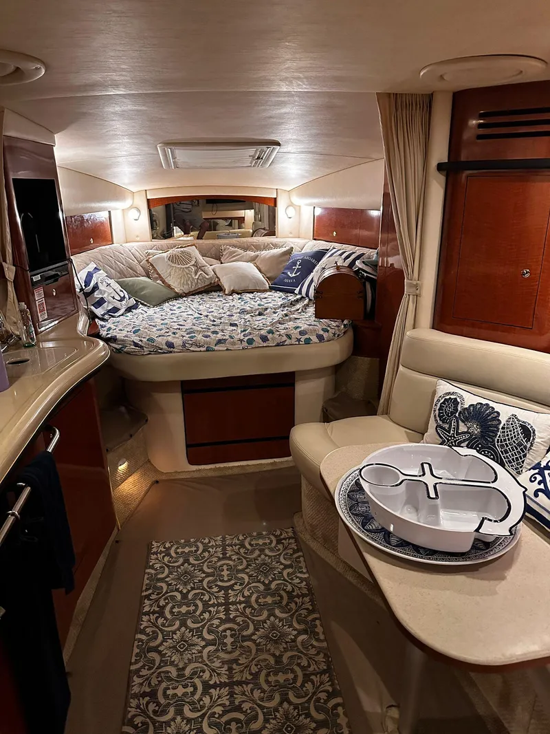 Slide: The Image of Interior of 2002 Sea Ray 320 Sundancer with cozy bed and dining area. - 5