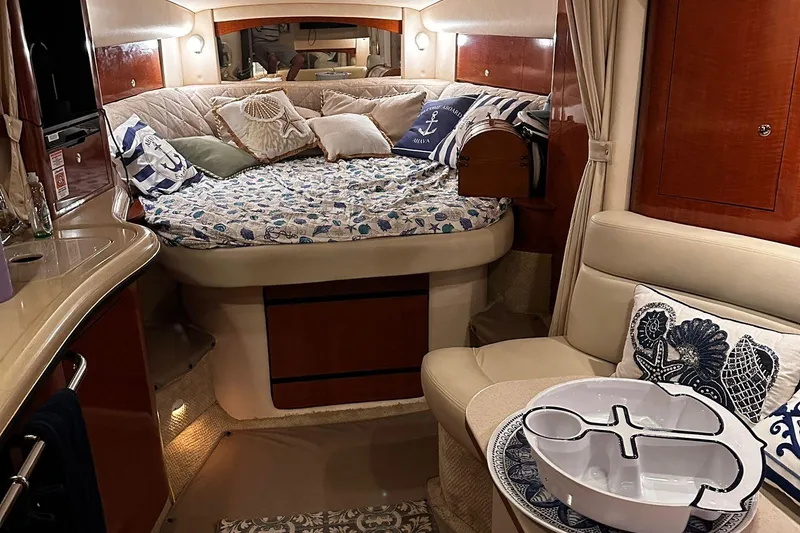 Slide: The Image of Luxurious 2002 Sea Ray 320 Sundancer cabin interior with cozy bedding and elegant decor. - 8