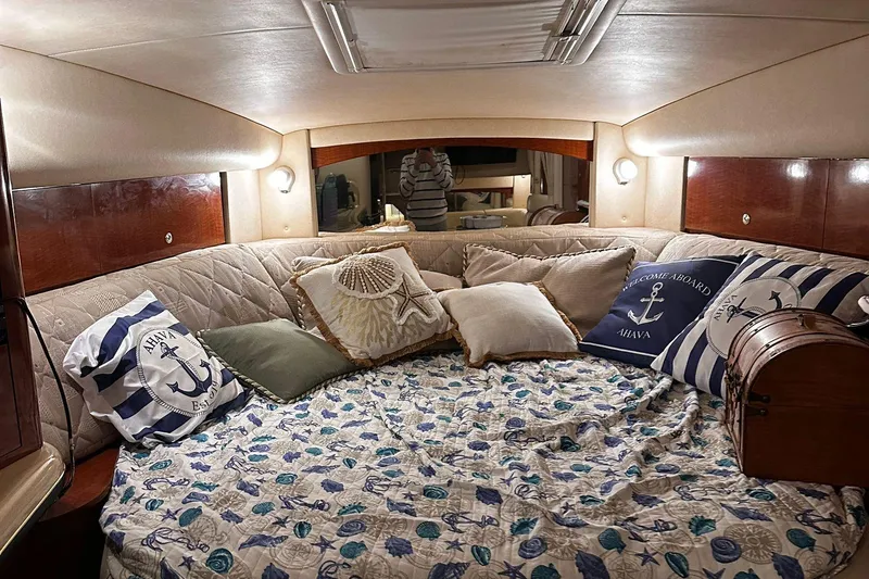 Slide: The Image of Cozy cabin interior of 2002 Sea Ray 320 Sundancer with nautical-themed decor. - 9