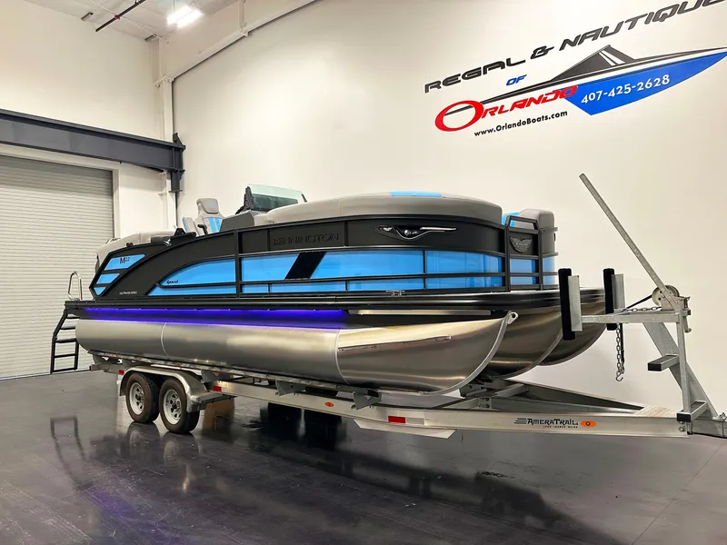 Slide: The Image of 2025 Bennington 22 MFBSE pontoon boat on trailer in showroom. - 4