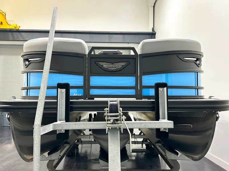 Slide: The Image of 2025 Bennington 22 MFBSE pontoon boat on trailer in showroom. - 5