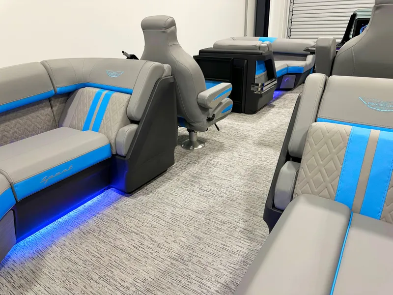 Slide: The Image of Luxurious interior of 2025 Bennington 22 MFBSE pontoon boat with blue LED lighting and plush seating. - 9