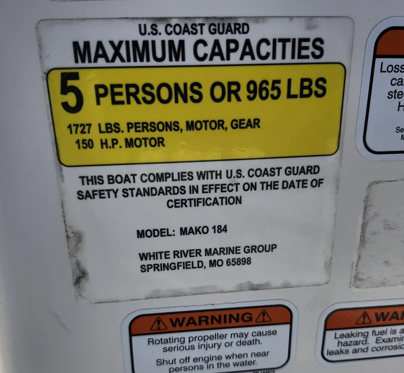 Slide: The Image of U.S. Coast Guard capacity label for 2019 Mako 184 CC boat, 5 persons or 965 lbs. - 12