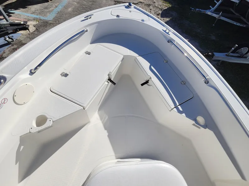 Slide: The Image of 2019 Mako 184 CC boat interior, featuring spacious seating and storage compartments. - 19