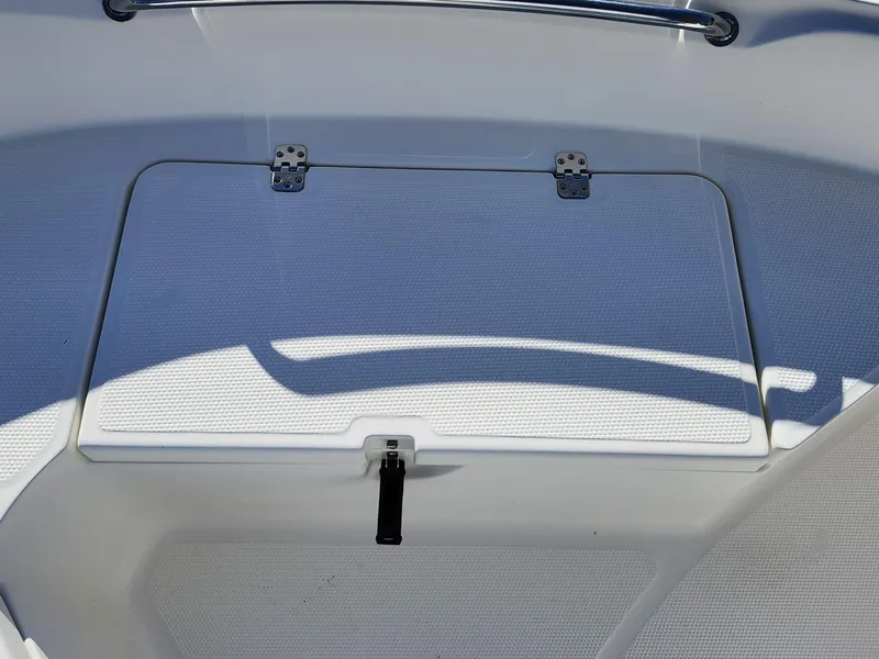 Slide: The Image of 2019 Mako 184 CC boat storage compartment with latch and hinges. - 21