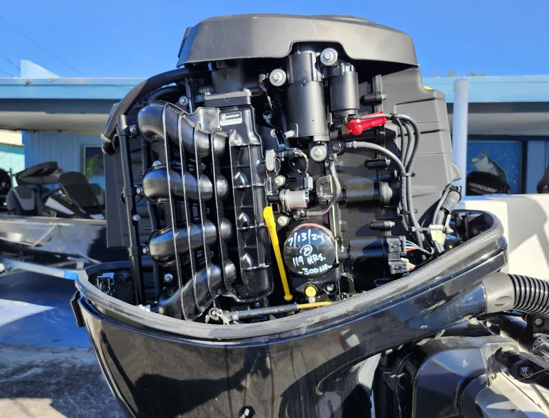 Slide: The Image of Close-up of a 2019 Mako 184 CC boat engine, showcasing intricate mechanical details. - 26