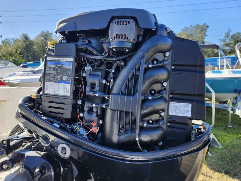 Slide: The Image of Close-up of a 2019 Mako 184 CC boat engine, showcasing intricate mechanical details. - 27