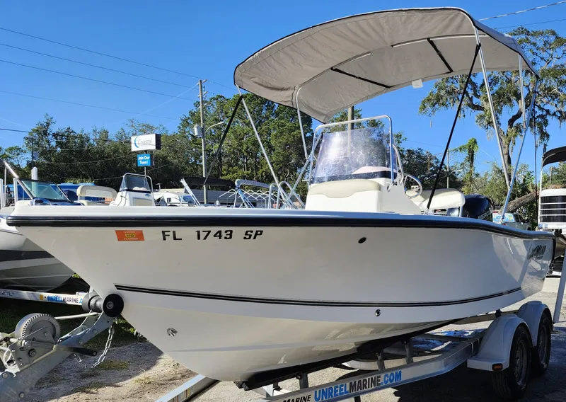 Slide: The Image of 2019 Mako 184 CC boat on trailer with canopy, parked outdoors. - 3