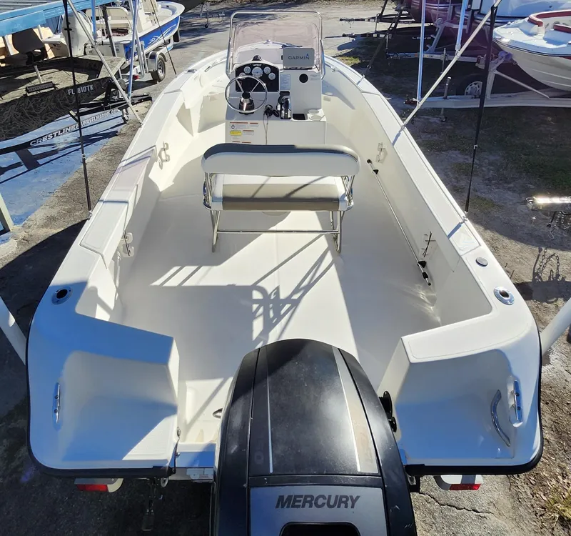 Slide: The Image of 2019 Mako 184 CC boat with Mercury engine, spacious deck, and center console. - 7