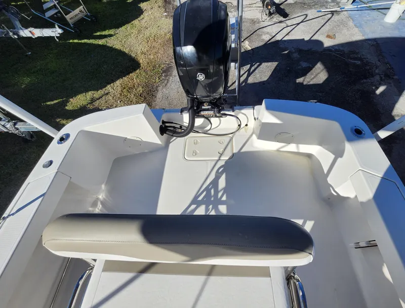 Slide: The Image of 2019 Mako 184 CC boat interior with outboard motor and seating area. - 8