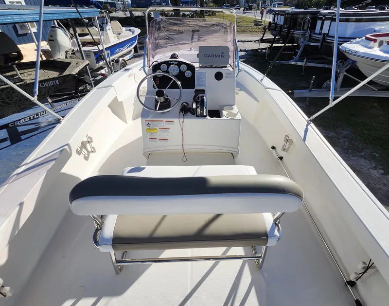 Slide: The Image of 2019 Mako 184 CC boat interior with steering console and seating. - 9