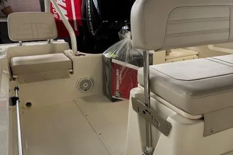 Slide: The Image of 2025 Boston Whaler 190 Montauk boat interior with cushioned seating and storage. - 11