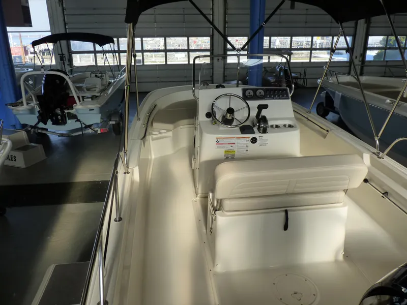 Slide: The Image of 2025 Boston Whaler 190 Montauk boat interior in showroom setting. - 12