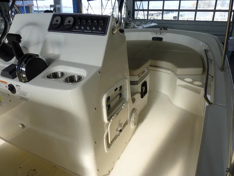 Slide: The Image of 2025 Boston Whaler 190 Montauk boat interior with console and seating area. - 14