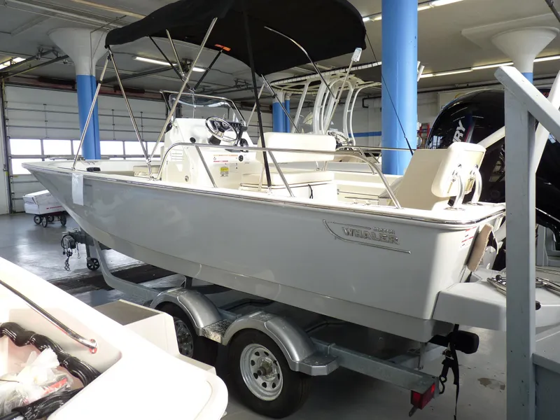 Slide: The Image of 2025 Boston Whaler 190 Montauk boat on trailer in showroom. - 2