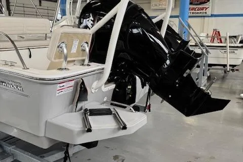 Slide: The Image of 2025 Boston Whaler 190 Montauk boat with powerful outboard motor in showroom. - 5