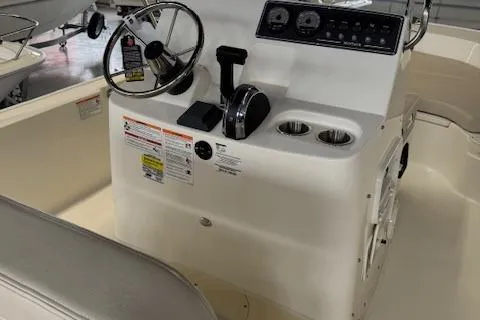 Slide: The Image of 2025 Boston Whaler 190 Montauk boat console with steering wheel and controls. - 8