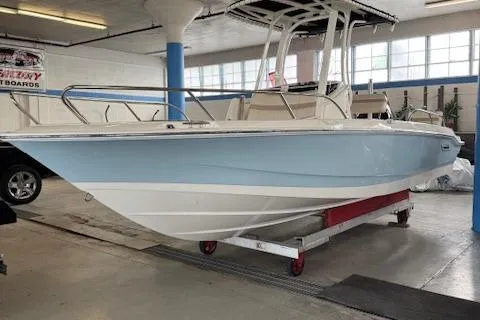 The Image of 2025 Boston Whaler 220 Dauntless boat in indoor storage, light blue hull. - 0