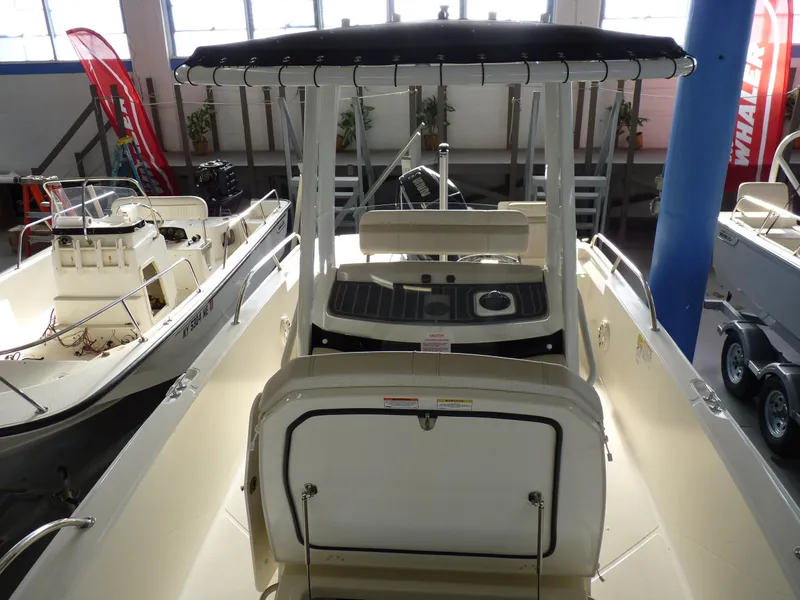 Slide: The Image of 2025 Boston Whaler 220 Dauntless boat interior with console and seating. - 11
