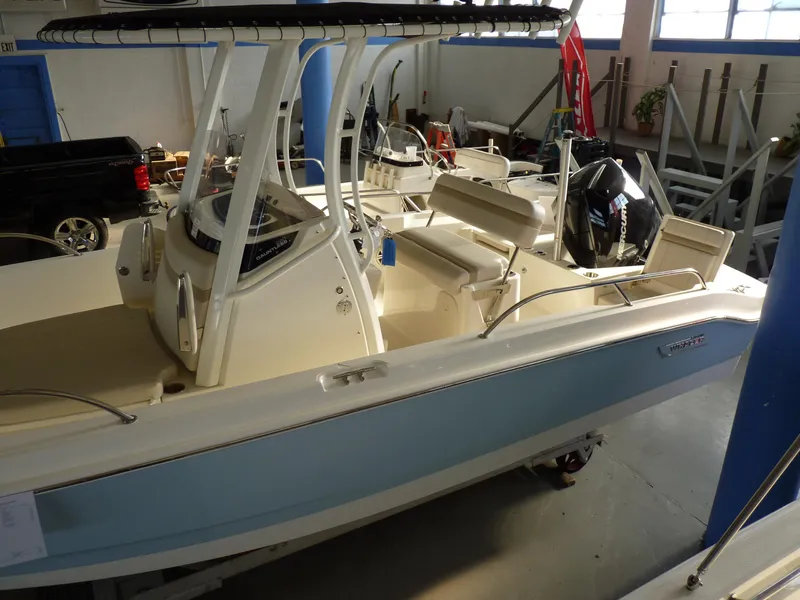 Slide: The Image of 2025 Boston Whaler 220 Dauntless boat in showroom, featuring sleek design and modern amenities. - 3