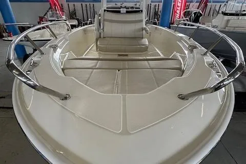 Slide: The Image of 2025 Boston Whaler 220 Dauntless boat interior with seating and stainless steel railings. - 4
