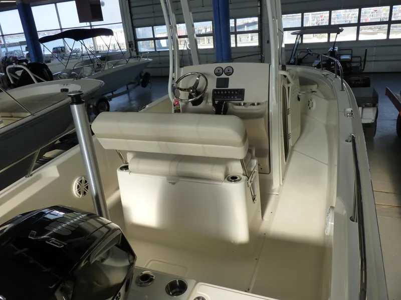 Slide: The Image of 2025 Boston Whaler 220 Dauntless boat interior with steering console and seating. - 8