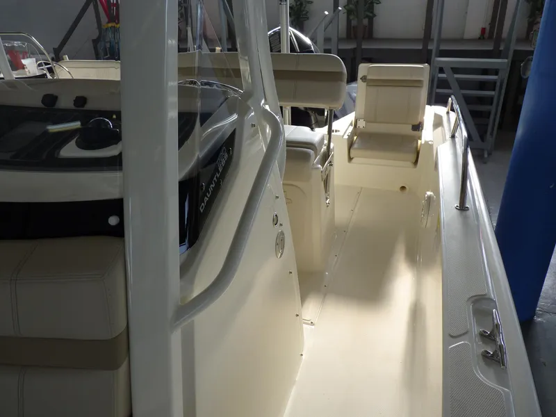 Slide: The Image of 2025 Boston Whaler 220 Dauntless interior, showcasing seating and helm area. - 9
