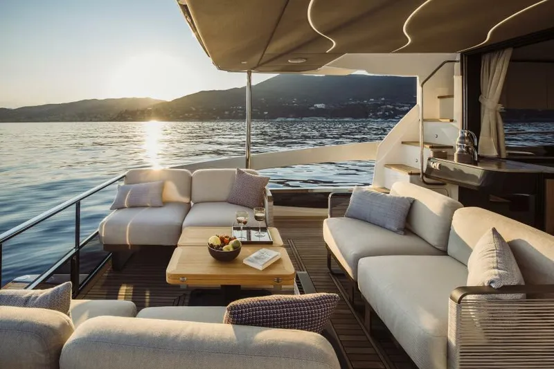 Slide: The Image of Luxurious 2026 Absolute 52 FLY yacht deck with elegant seating at sunset. - 2