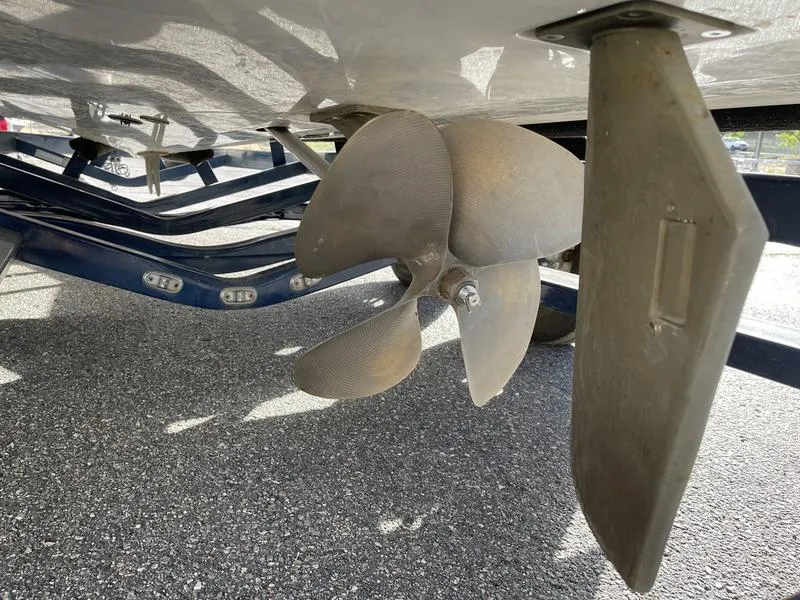 Slide: The Image of Close-up of 2017 Malibu 21 VLX boat propeller and rudder on a trailer. - 10