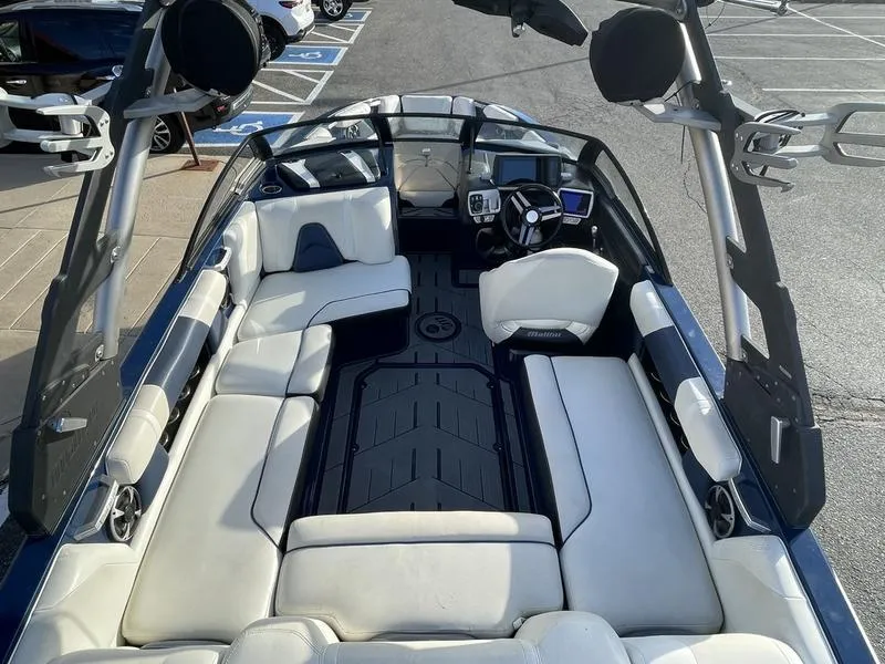 Slide: The Image of 2017 Malibu 21 VLX boat interior with spacious seating and modern dashboard. - 15