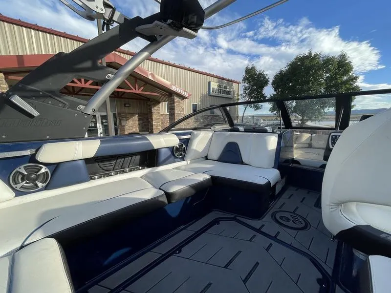 Slide: The Image of 2017 Malibu 21 VLX boat interior with white seating and modern design. - 16