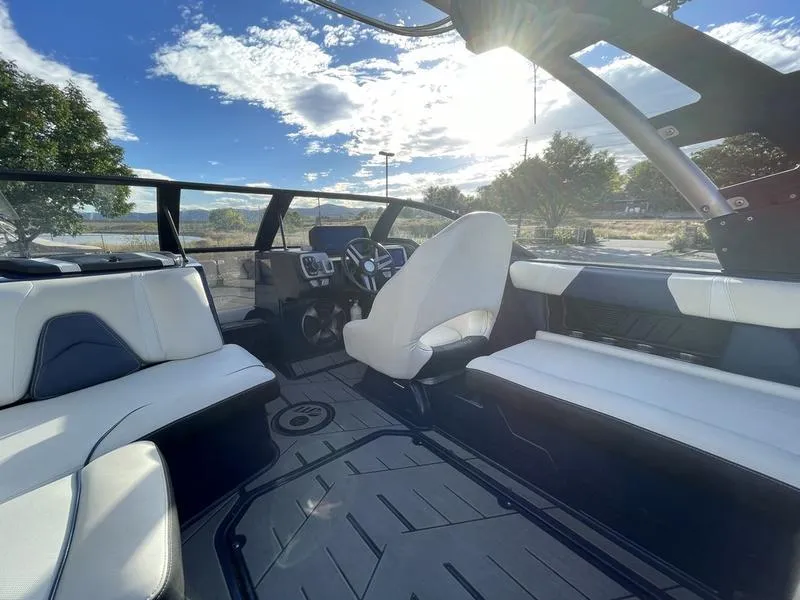 Slide: The Image of 2017 Malibu 21 VLX boat interior with sleek seating and modern dashboard. - 17