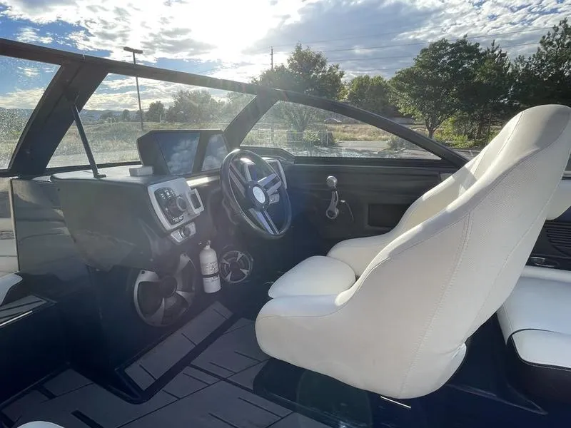 Slide: The Image of Interior of 2017 Malibu 21 VLX boat with steering wheel and dashboard controls. - 19