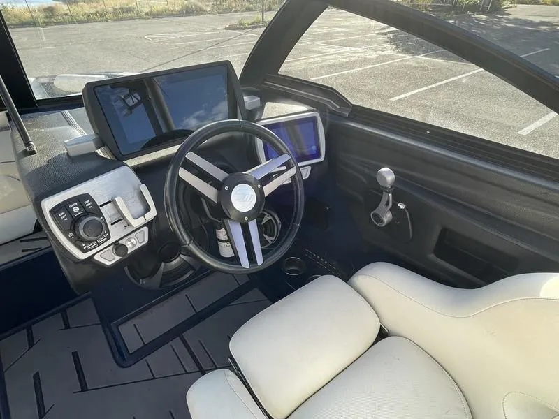Slide: The Image of 2017 Malibu 21 VLX boat interior with steering wheel and control panel. - 20