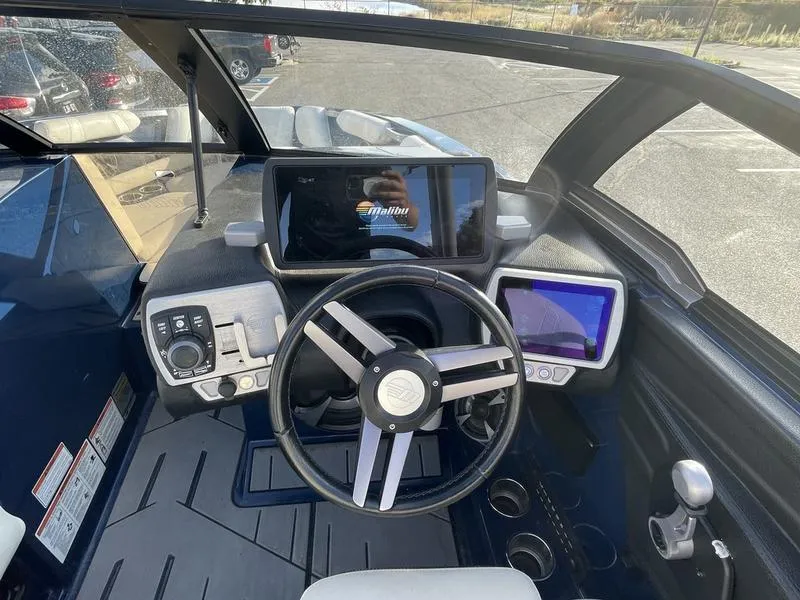 Slide: The Image of 2017 Malibu 21 VLX boat dashboard with steering wheel and digital displays. - 22