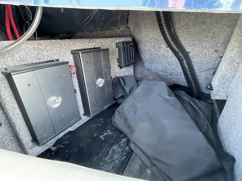 Slide: The Image of 2017 Malibu 21 VLX interior storage with electronic components and wiring. - 23